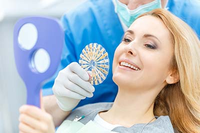 woman smiling at her cosmetic dentistry appointment in Ashland, OH